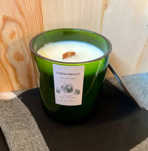 Load image into Gallery viewer, Green glass candle jar, with wood wick on white black check table cloth