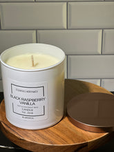 Load image into Gallery viewer, 9 oz round white candle jar with copper color lid on wood stand and white subway tile background, with cotton wick, black raspberry vanilla scent. 
